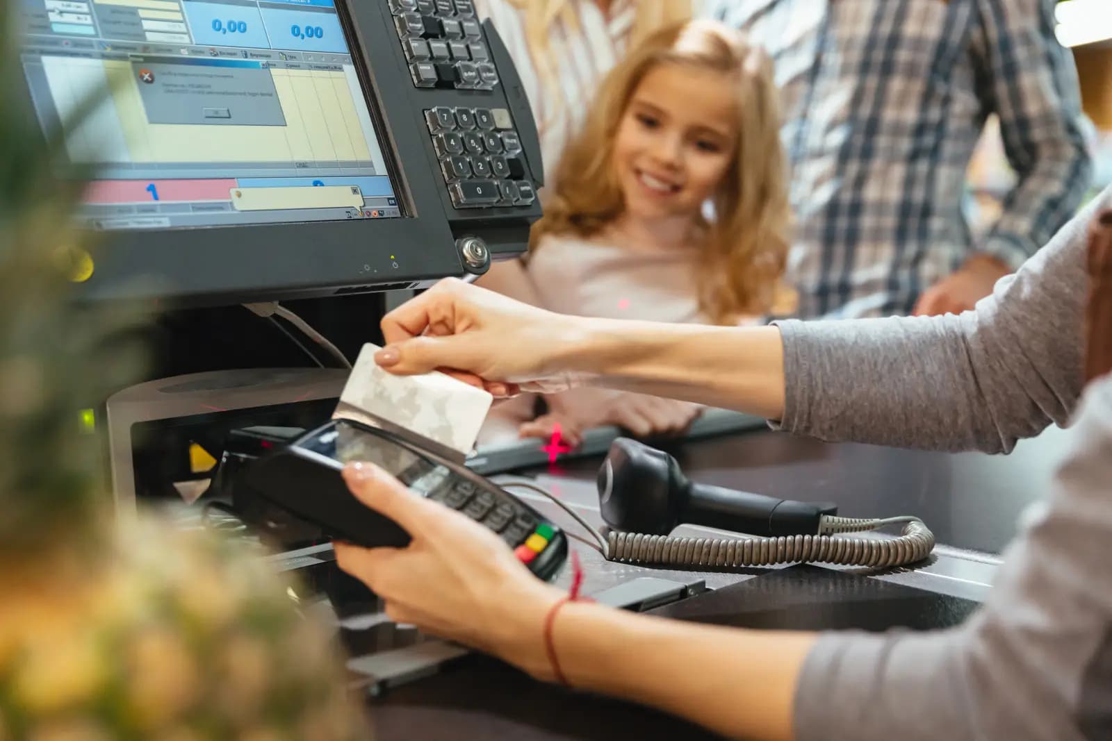 Staff member ringing up a customer at a card terminal