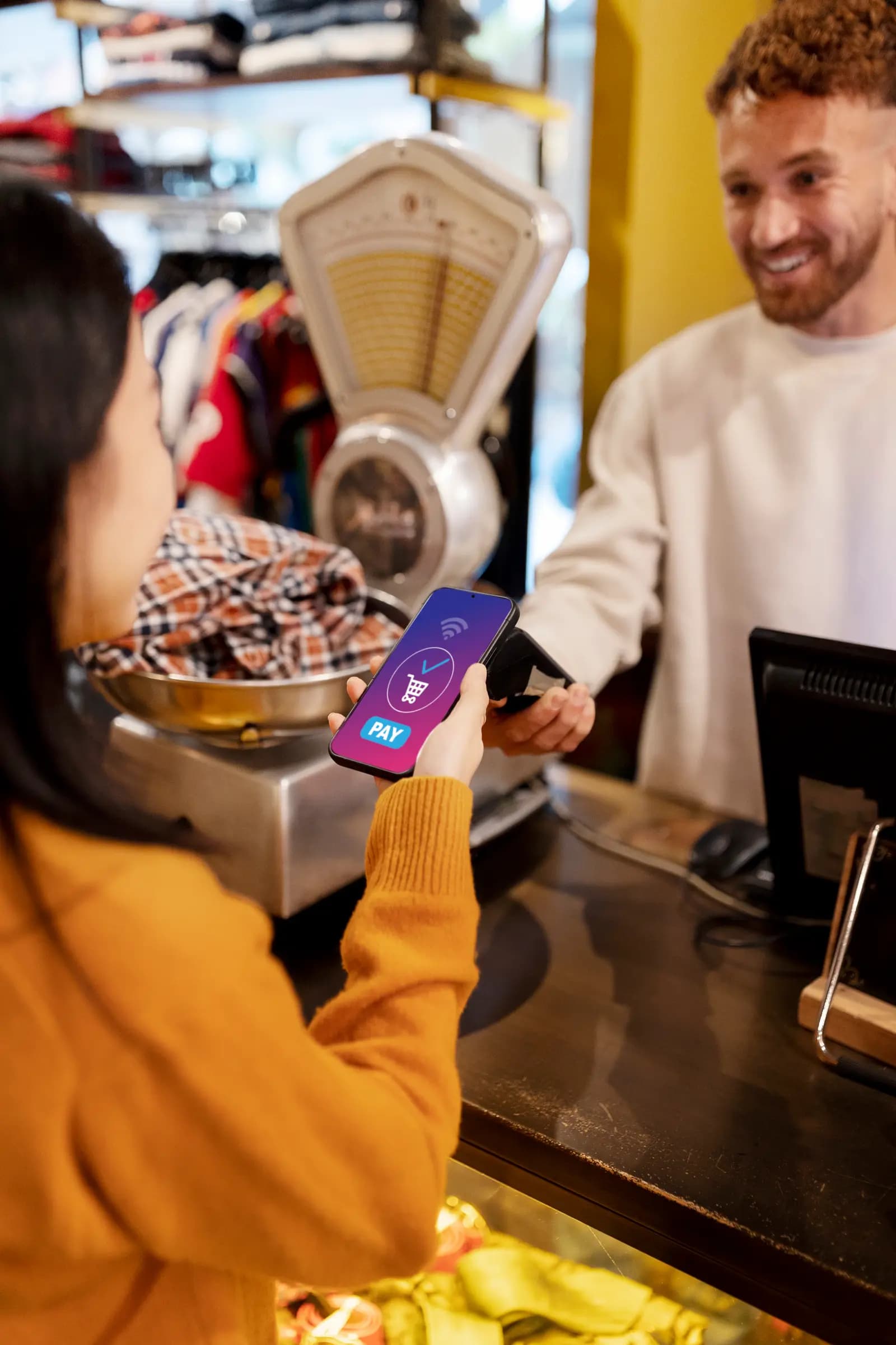 Customer paying with a phone at a store counter